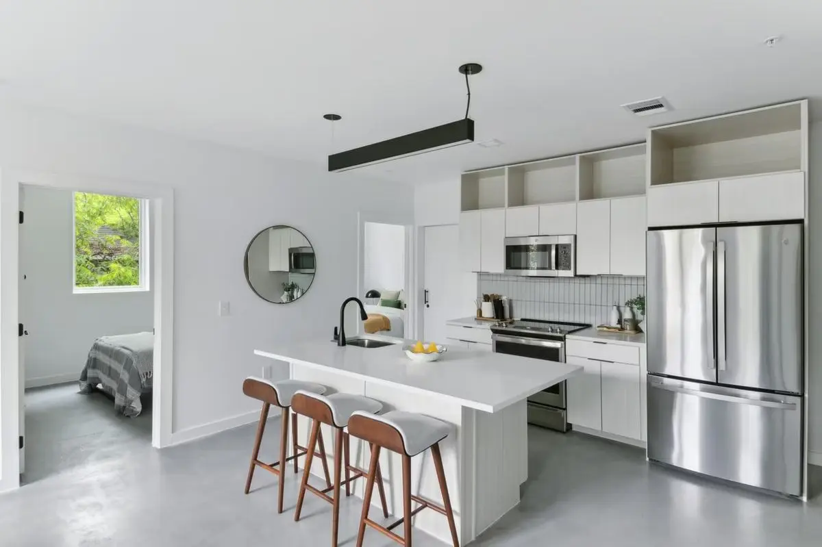 Open-concept kitchen and shared living area with bar seating at Capitol Living