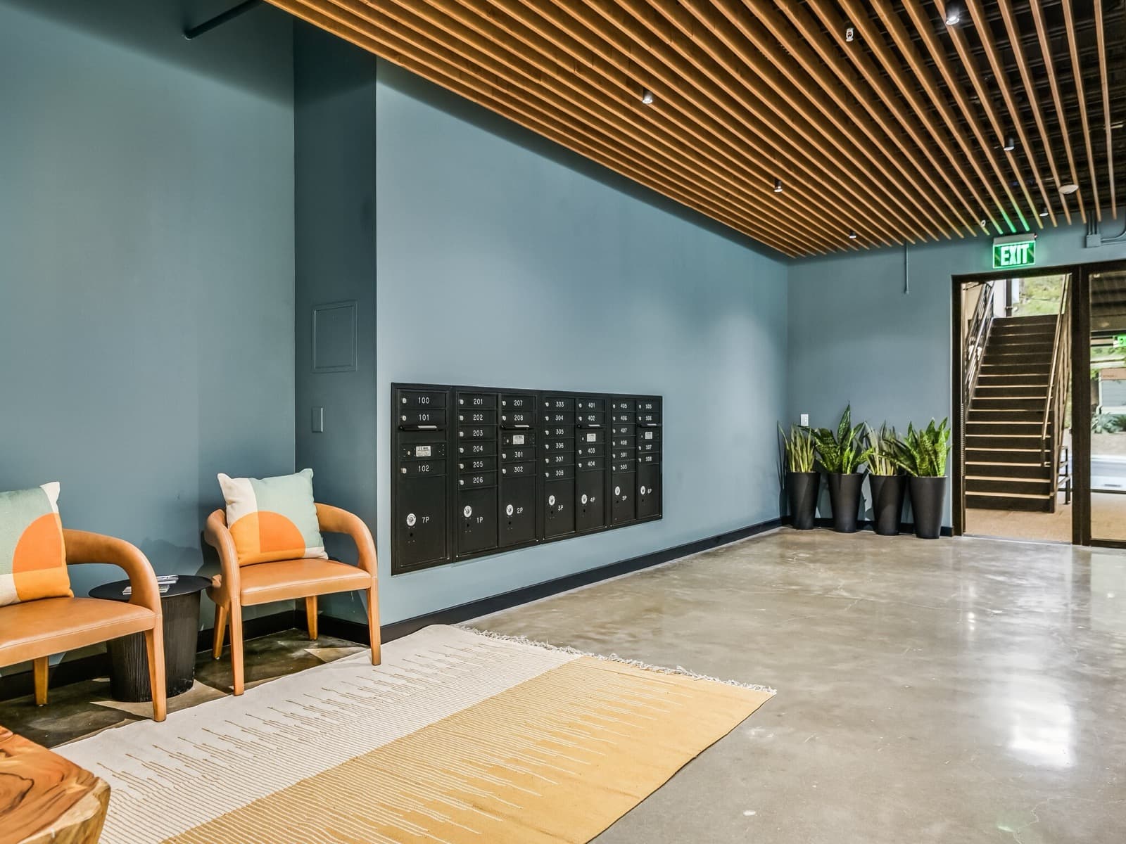 Capitol Living lobby with resident mailboxes and wood-slat ceiling