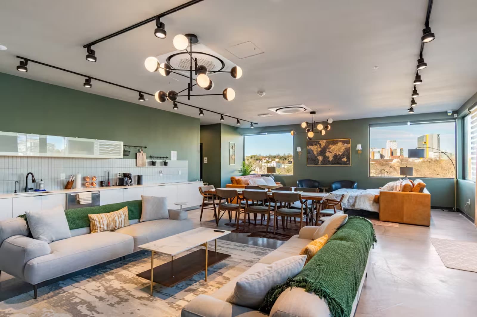Capitol Living penthouse lounge with sectional sofa and statement chandelier