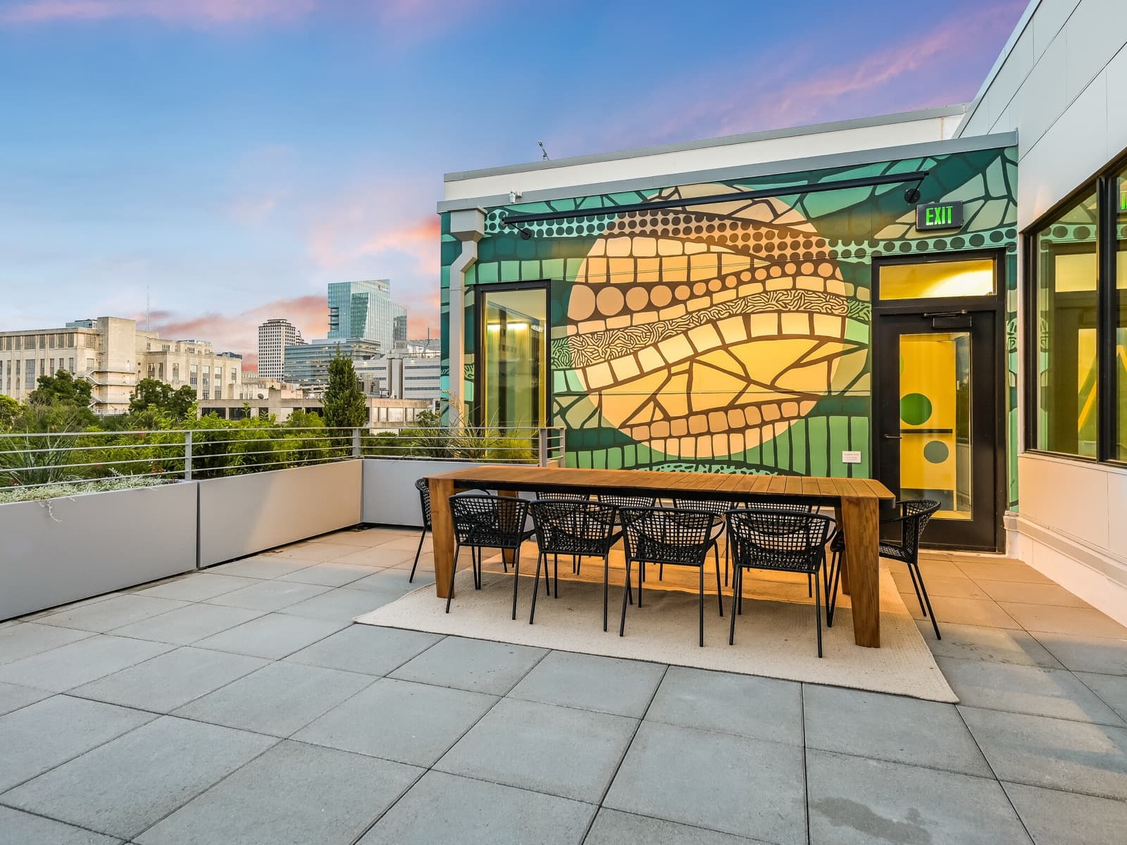 Capitol Living rooftop terrace at sunset with panoramic city views
