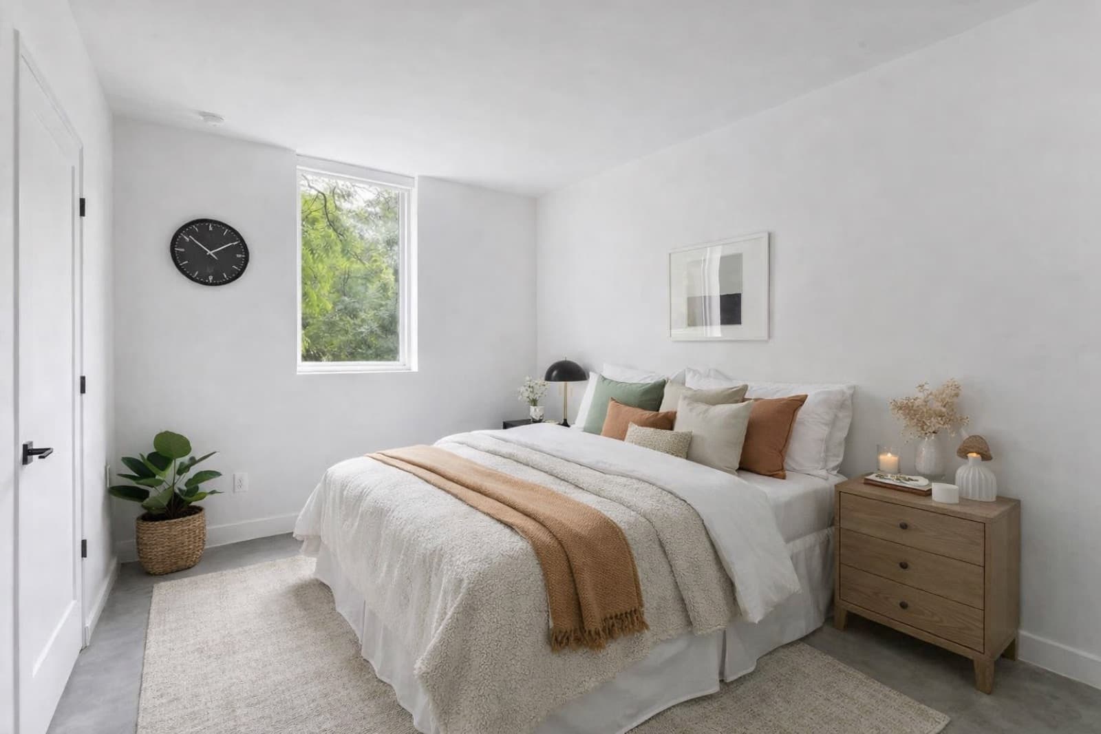 Bedroom with a solid-core door, window, and polished concrete floor at Capitol Living