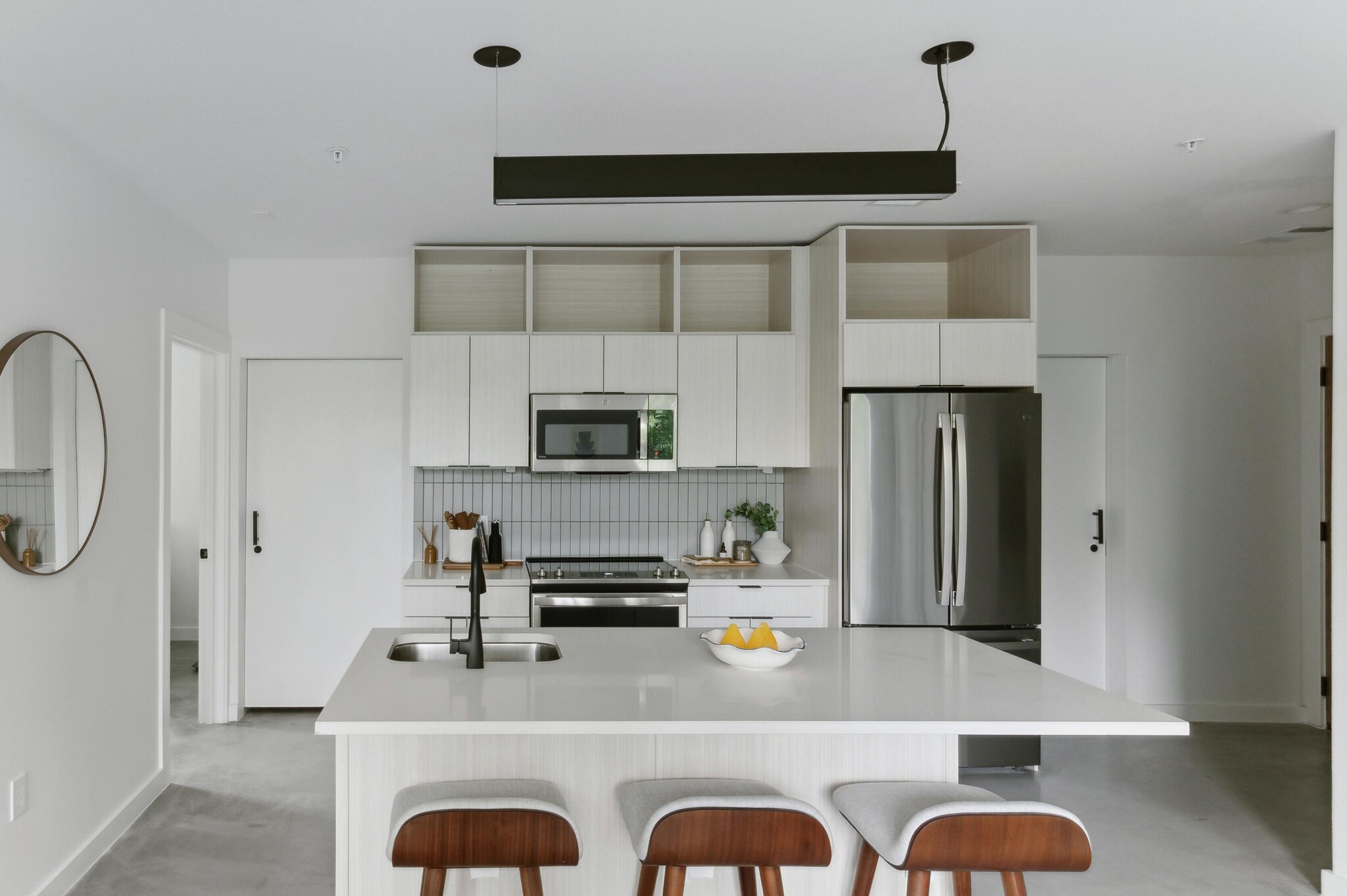 Open-concept kitchen with quartz island in a Capitol Living apartment